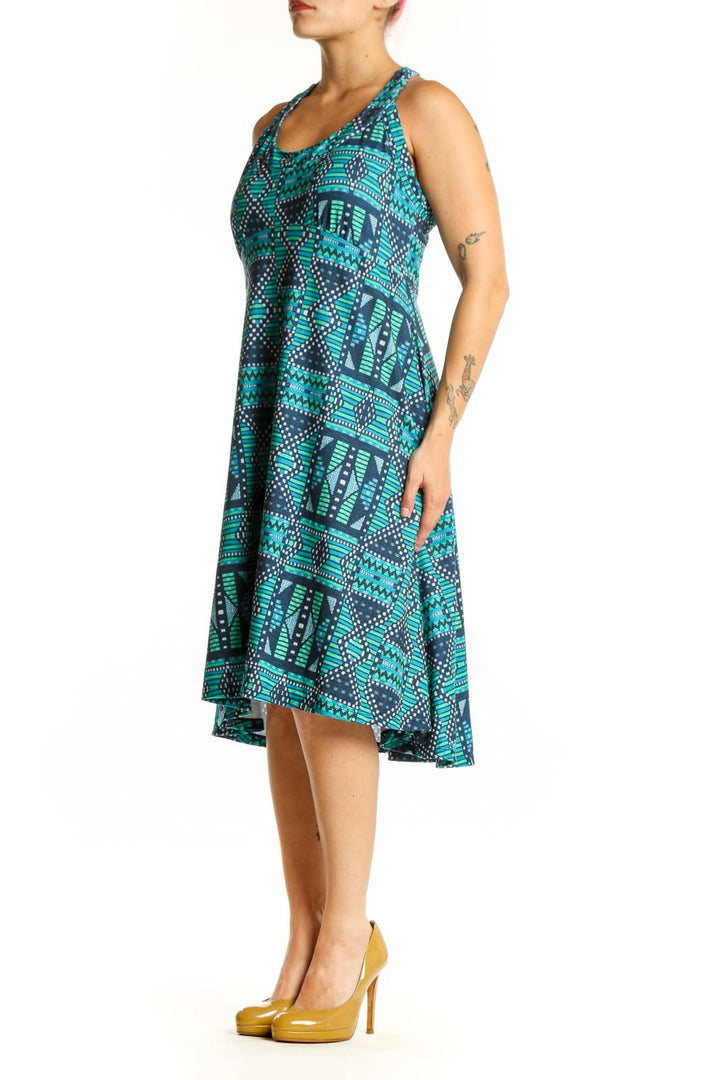 Turquoise and navy geometric halter dress with tribal pattern, front view on model