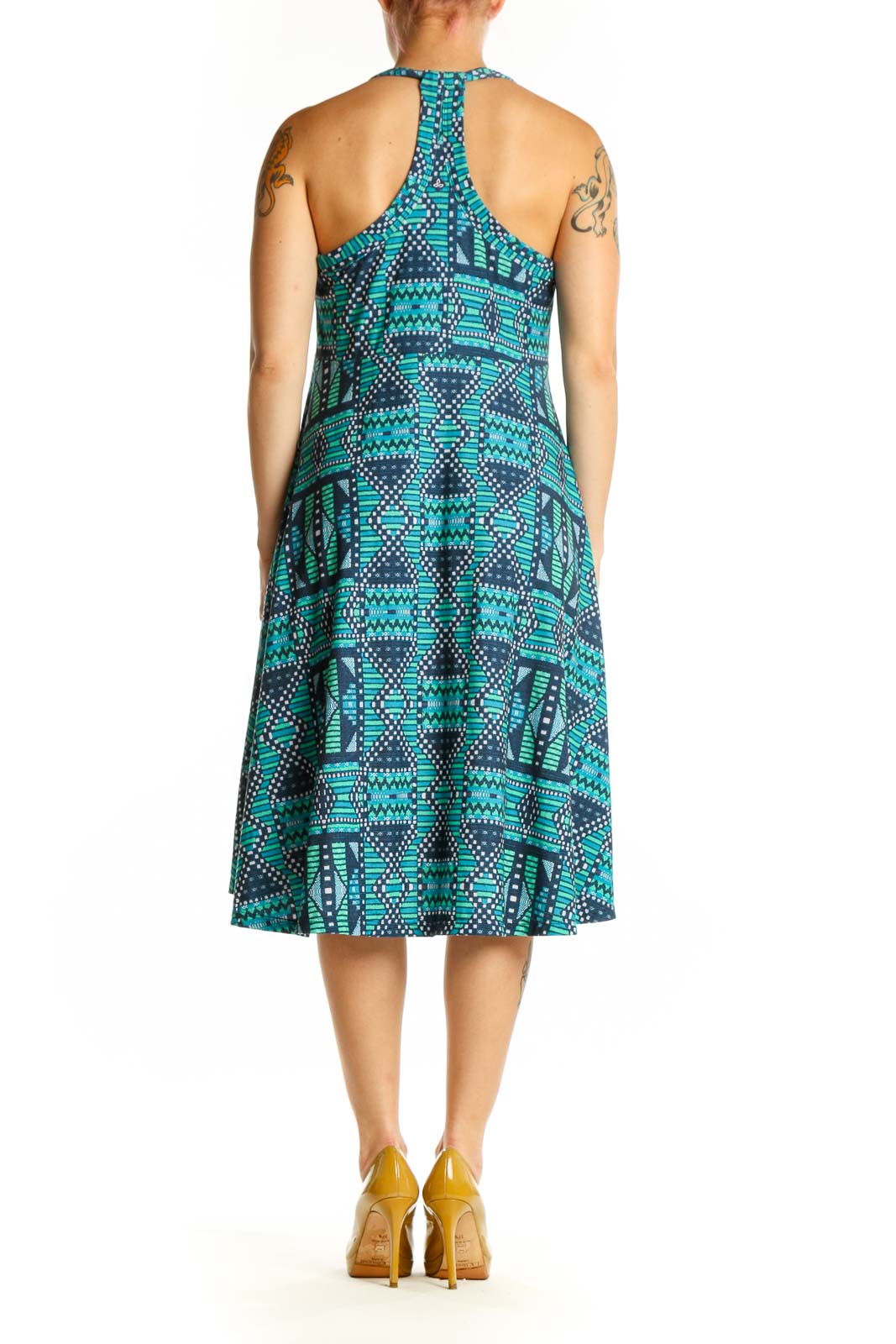 Turquoise and navy geometric halter dress with asymmetrical hemline, back view on model