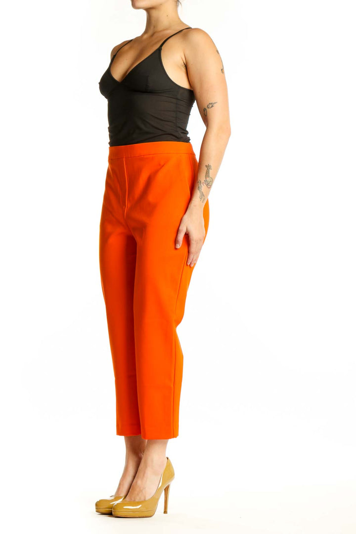 Front view of vibrant orange cropped pants by Rachel Zoe with high-waisted design and ankle length