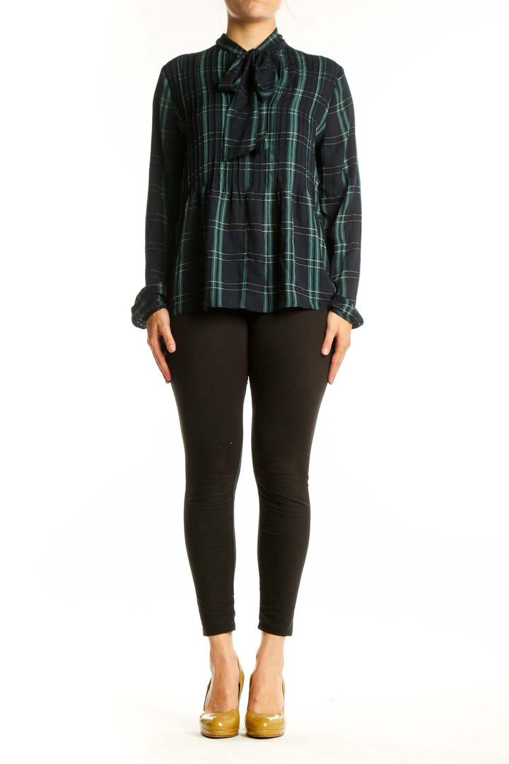 Navy and green plaid tie-neck blouse with long sleeves and A-line silhouette, front view