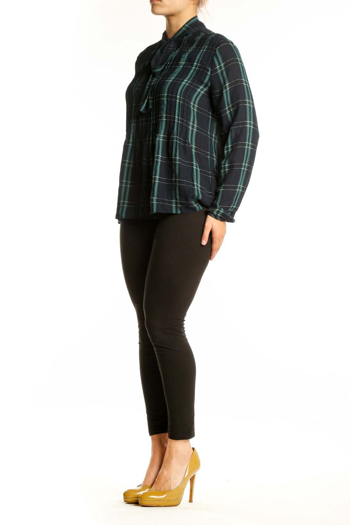 Navy and green plaid tie-neck blouse with long sleeves and A-line silhouette, front view