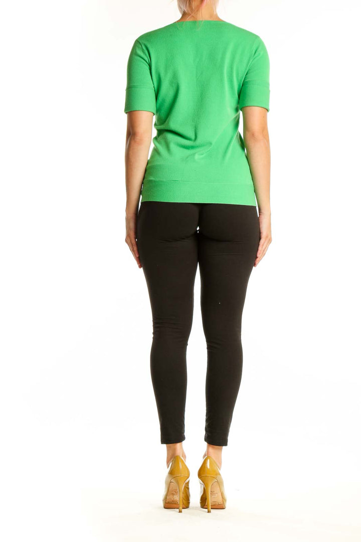 Green viscose knit top with ruffle detail, back view showing fitted silhouette