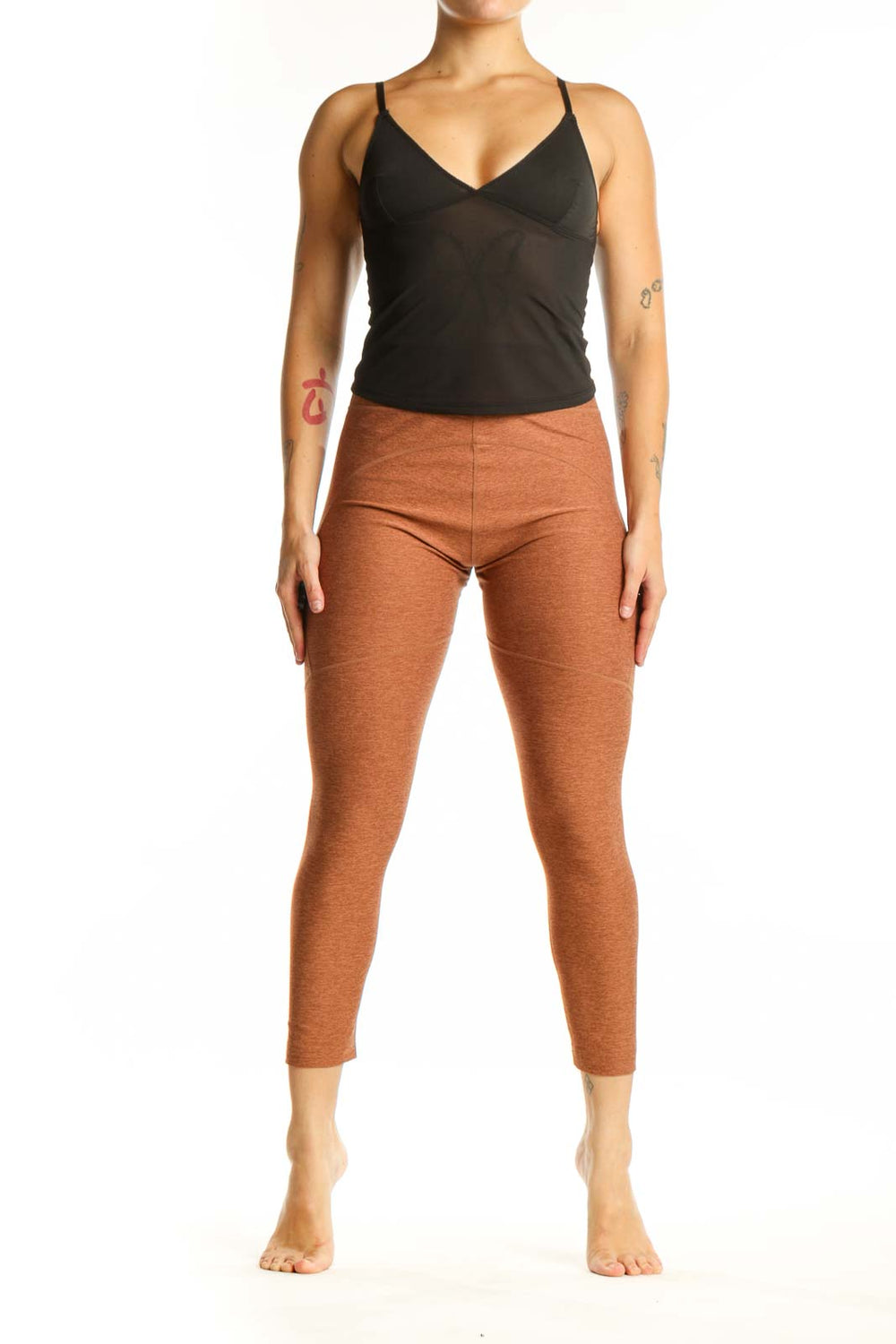Front view of orange heathered cropped leggings with high-waisted fit and calf-length cut