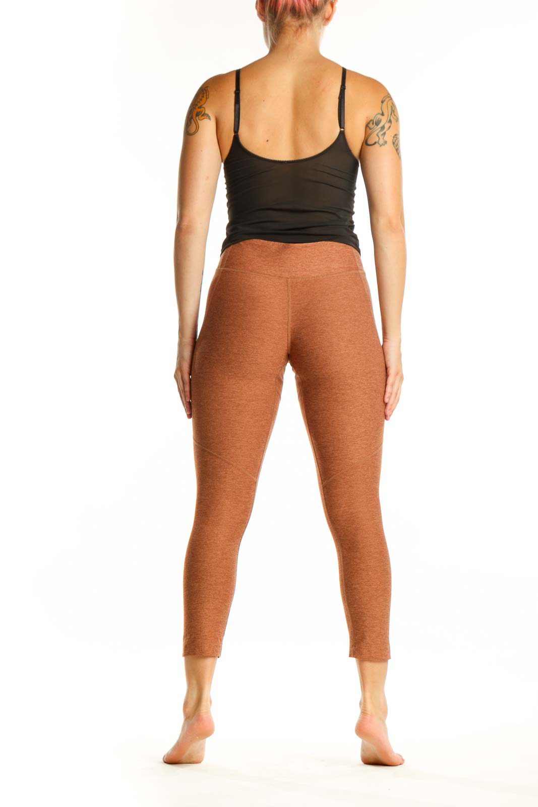 Back view of orange heathered cropped leggings showing seamless construction and flattering silhouette