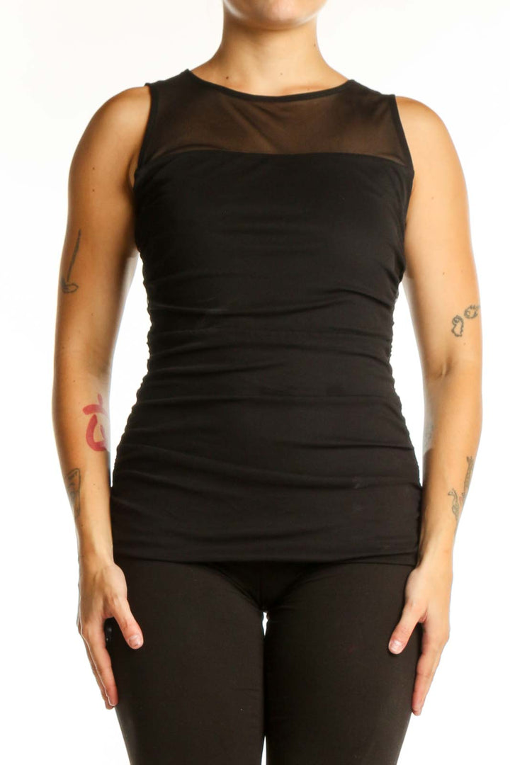 Black ruched sleeveless tank top with mesh neckline panel, front view on model