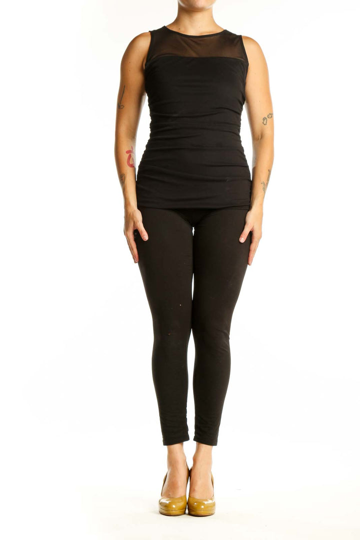 Black ruched sleeveless tank top with mesh neckline panel, front view on model