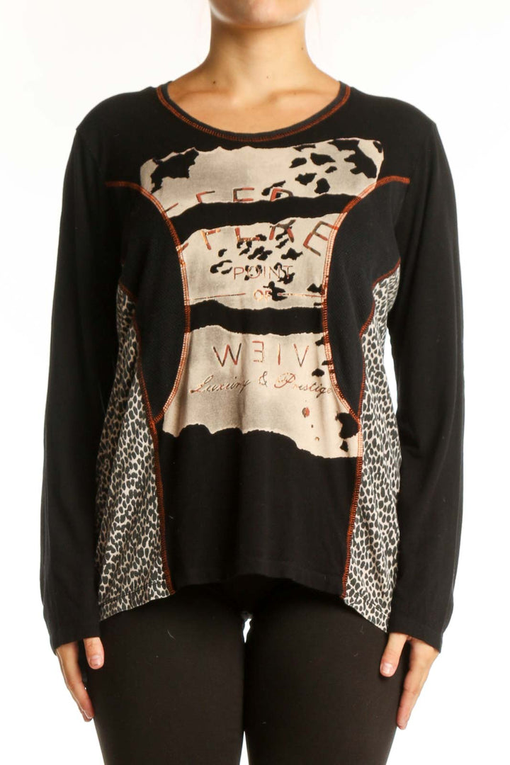 Black mixed pattern long sleeve top with cream, beige, and rust accents featuring animal print and geometric designs
