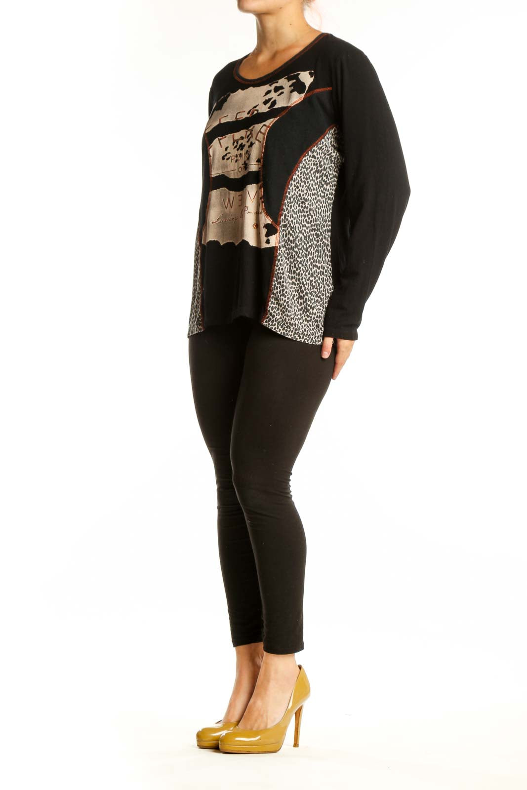 Black mixed pattern long sleeve top with cream, beige, and rust accents featuring animal print and geometric designs