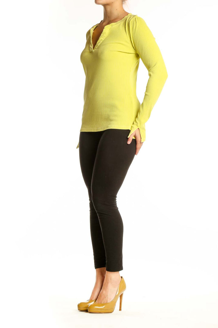 Yellow ribbed henley knit top with button neckline and long sleeves, front view