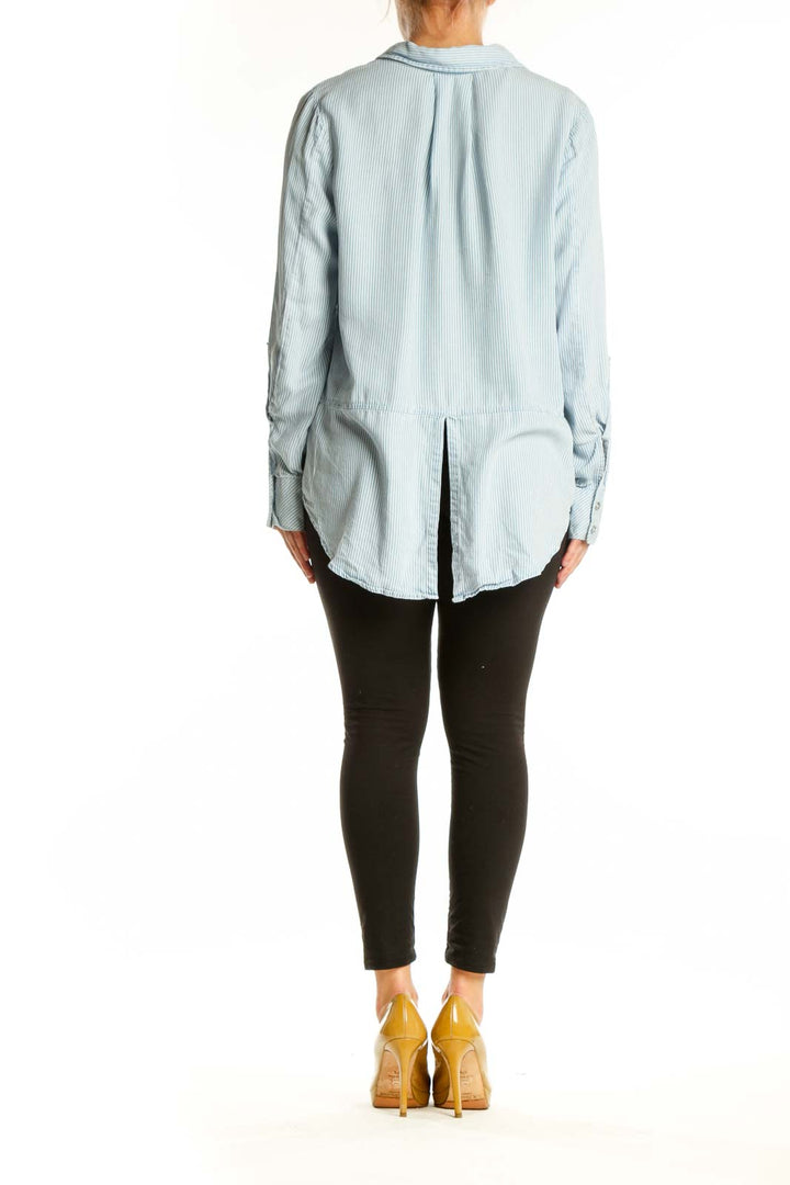 Light blue and white striped Calvin Klein Jeans button-up shirt, back view showing relaxed fit