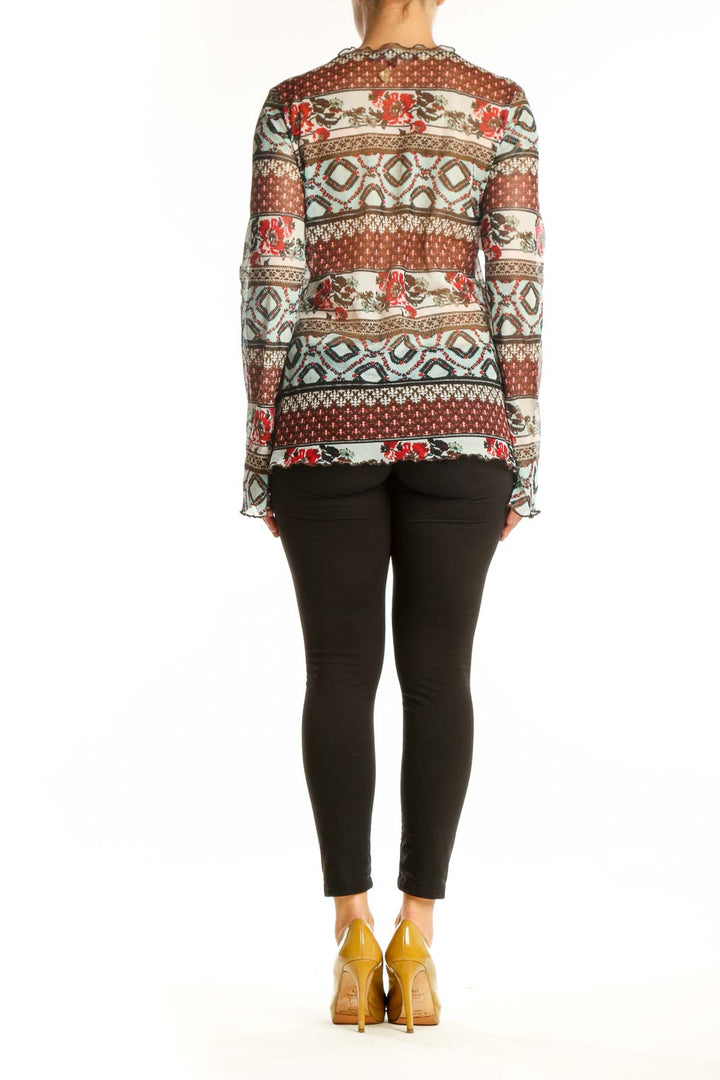 Back view of rust patchwork knit top showing mixed pattern design and long sleeve construction