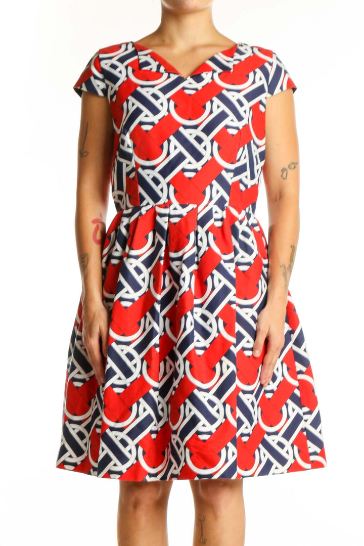 Red, navy, and white geometric print A-line dress with V-neckline and cap sleeves, front view