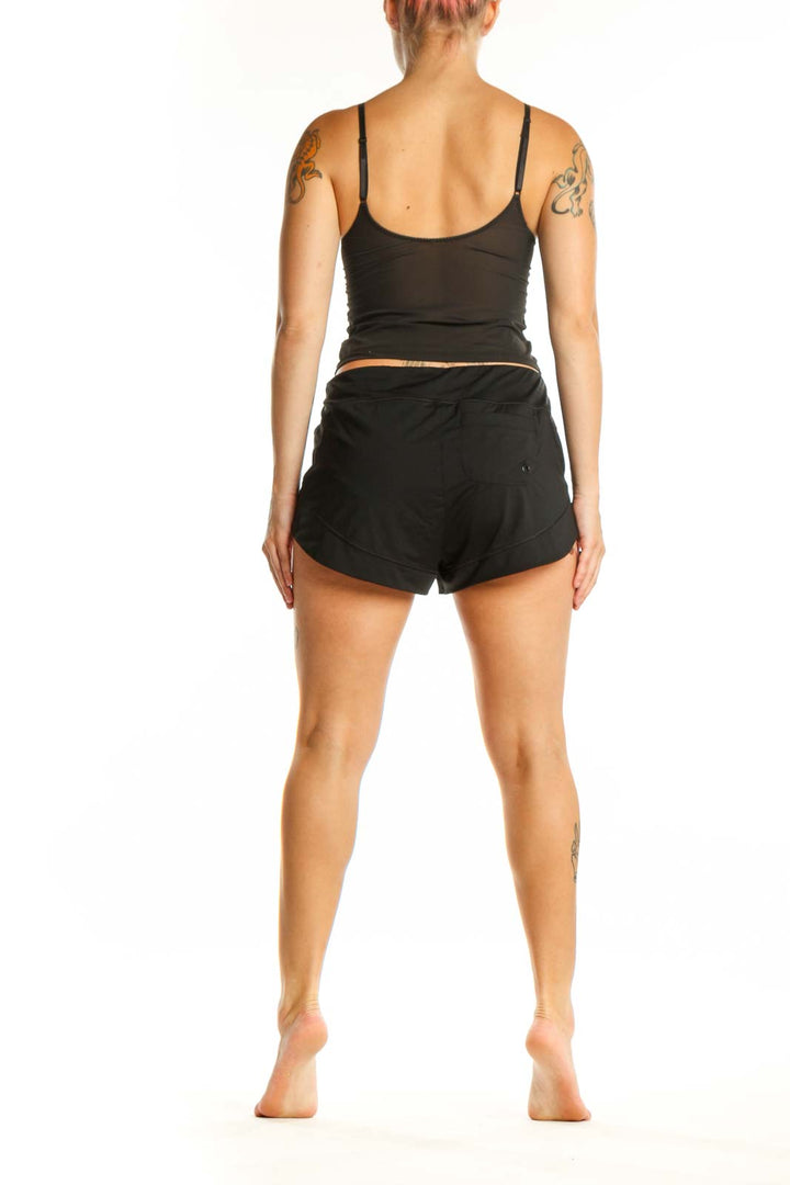 Black athletic shorts back view displaying sleek design and flattering silhouette with wraparound waistband