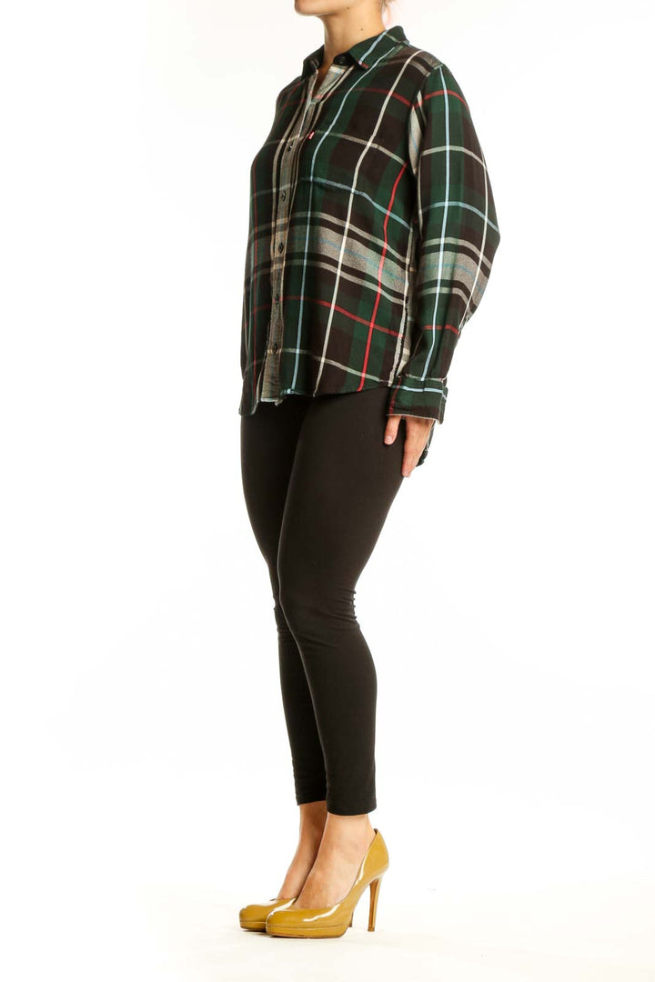 Black plaid flannel shirt with green, red, and cream pattern, button-up front with gray chambray placket, long sleeves