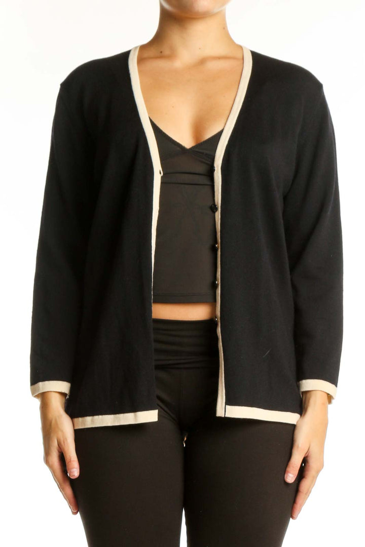 Black wool ESCADA cardigan with cream trim, V-neckline, and button-front closure worn over black top