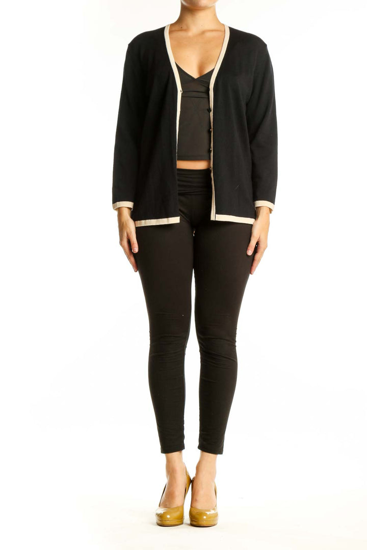 Black wool ESCADA cardigan with cream trim, V-neckline, and button-front closure worn over black top