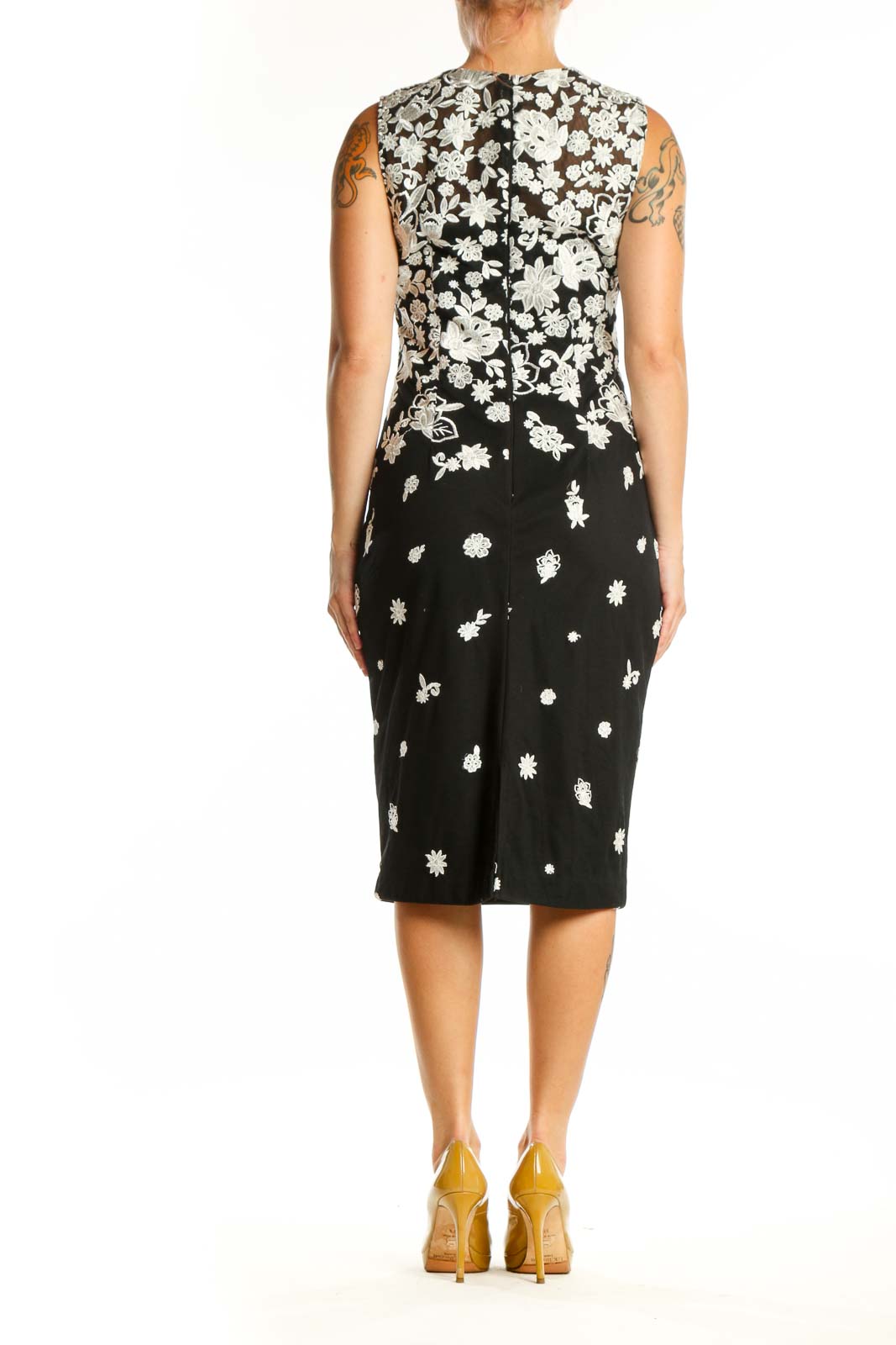 Back view of black floral midi dress showing elegant drape and fitted waist design