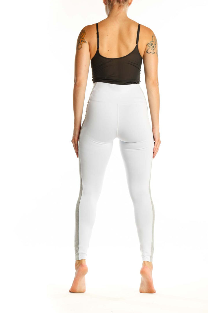 White high-waist leggings with gray side paneling, back view showing fitted silhouette