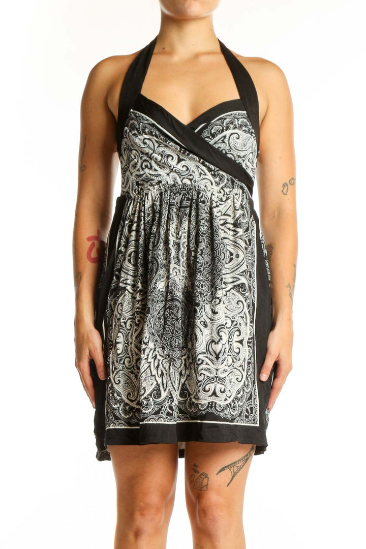 Black and white ornamental halter dress with paisley pattern and wrap-front design, front view