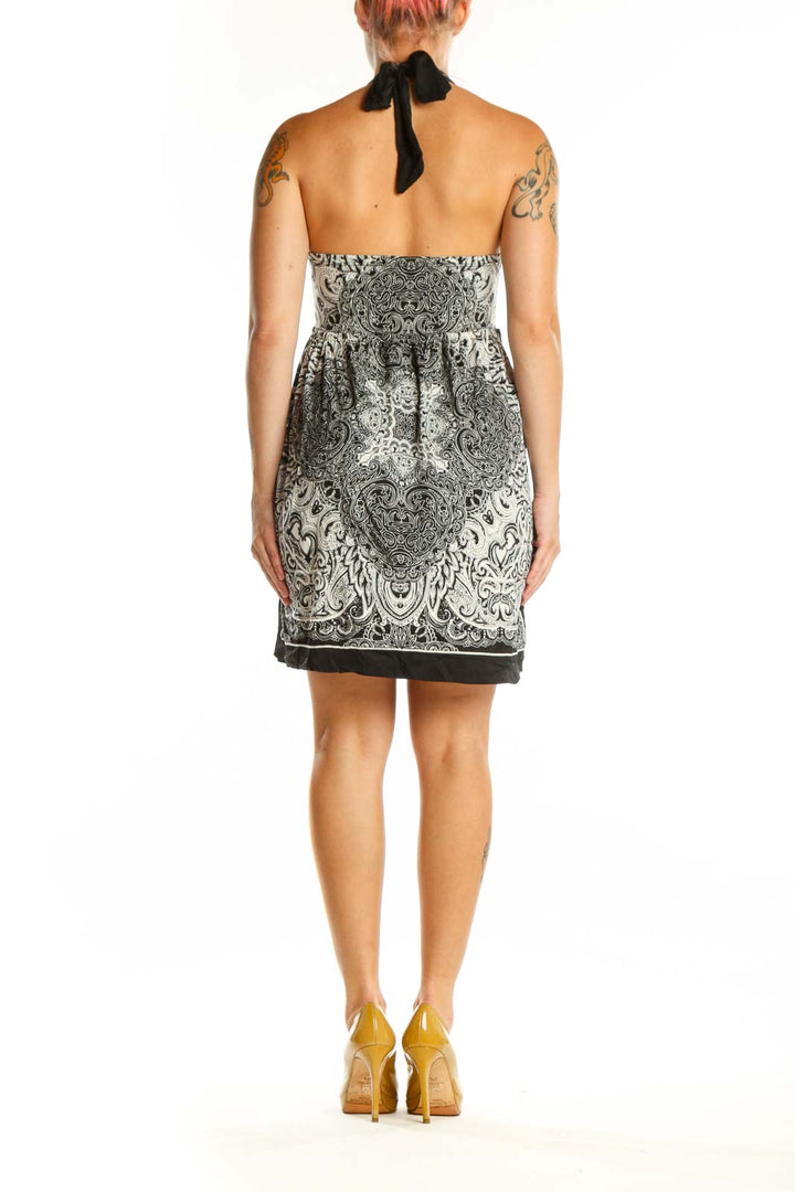 Black and white ornamental halter dress with paisley pattern and adjustable halter straps, back view
