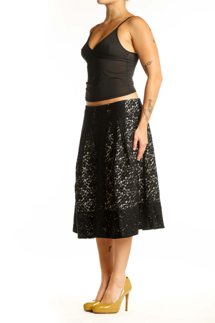 Black lace A-line midi skirt front view, featuring all-over lace pattern and flattering silhouette