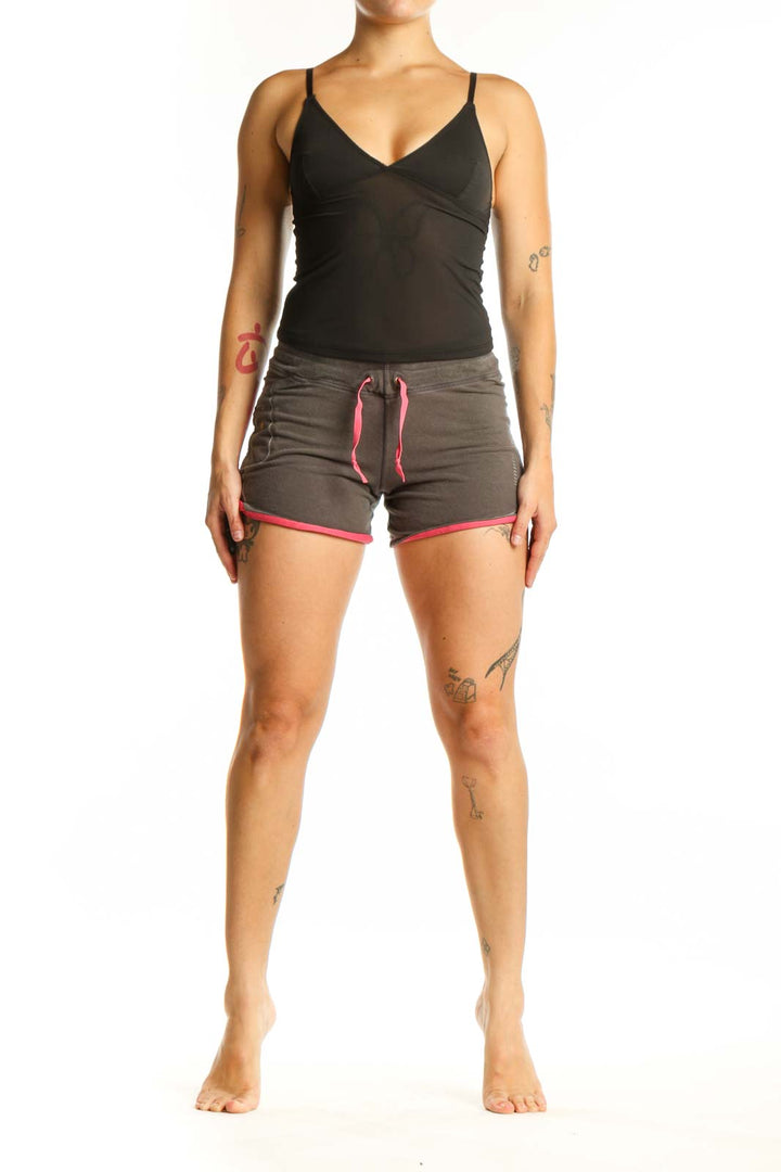 Front view of gray and pink Nike athletic shorts with drawstring waistband and pink trim details