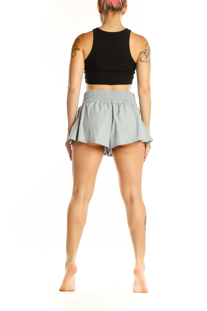 Gray ruched athletic skort with flared silhouette, back view