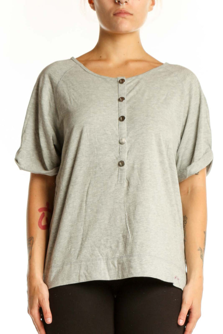 Beige button-front short sleeve top with rolled sleeves, front view on model