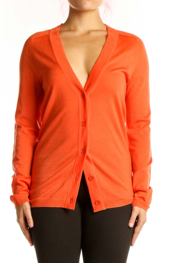 Front view of orange merino wool cardigan with button-front closure and V-neckline