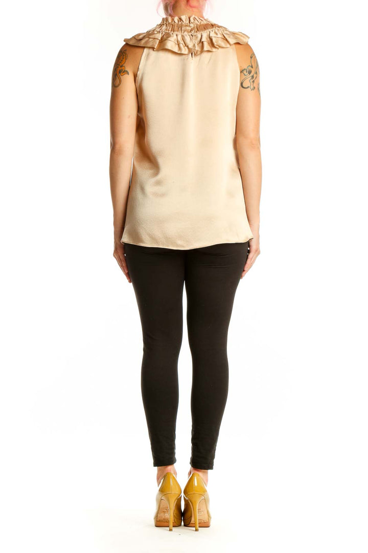 Cream sleeveless blouse with ruffled neckline by Milly, back view