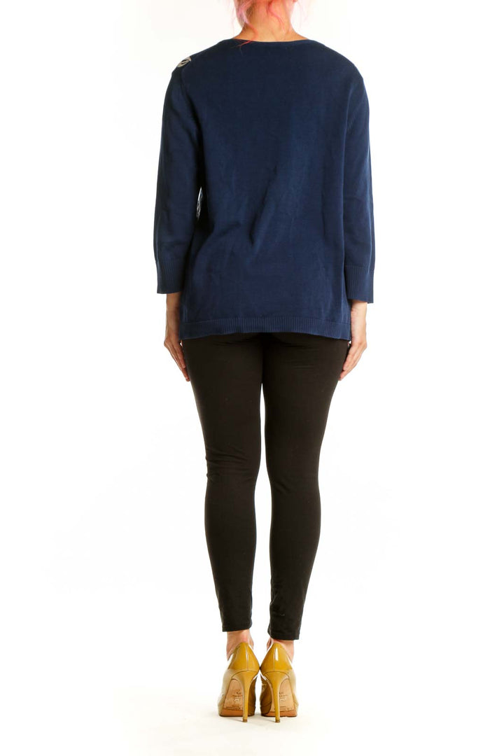 Back view of navy sailboat cardigan showing full pattern coverage and ribbed sleeve detail