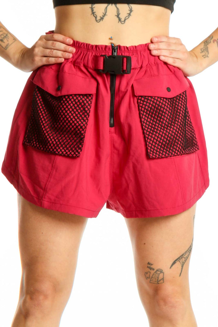 Red athletic shorts with mesh pockets and drawstring waistband, front view