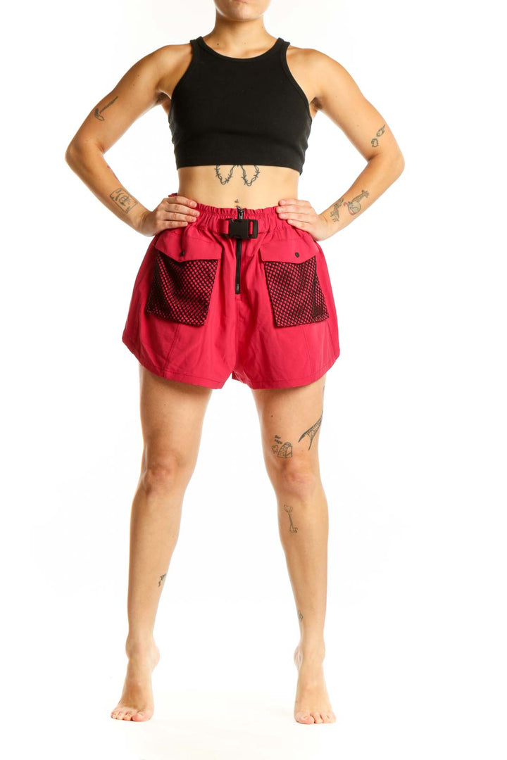 Red athletic shorts with mesh pockets and drawstring waistband, front view