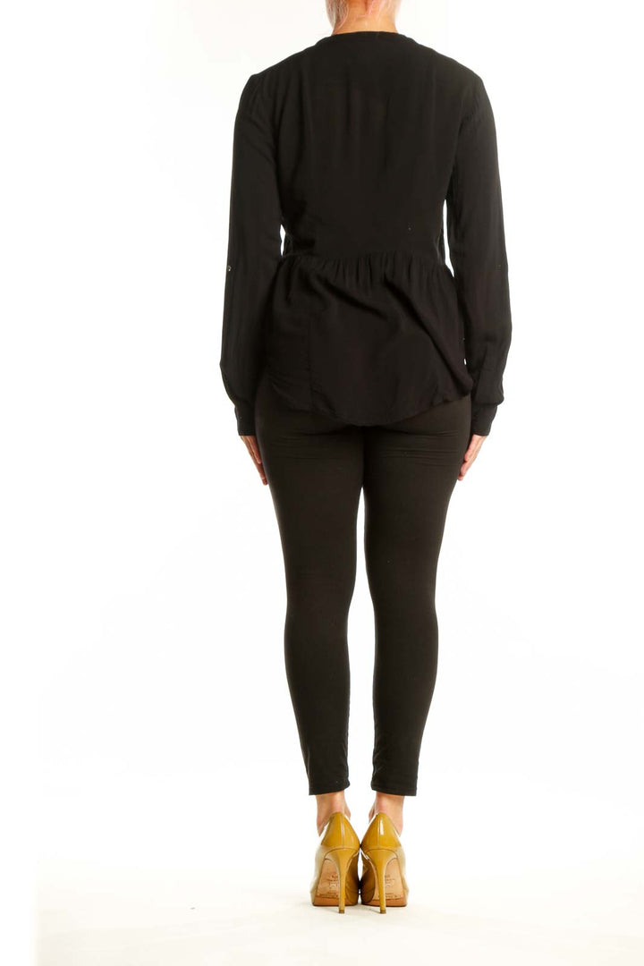 Black rayon button-front pleated blouse back view showing relaxed fit and draping