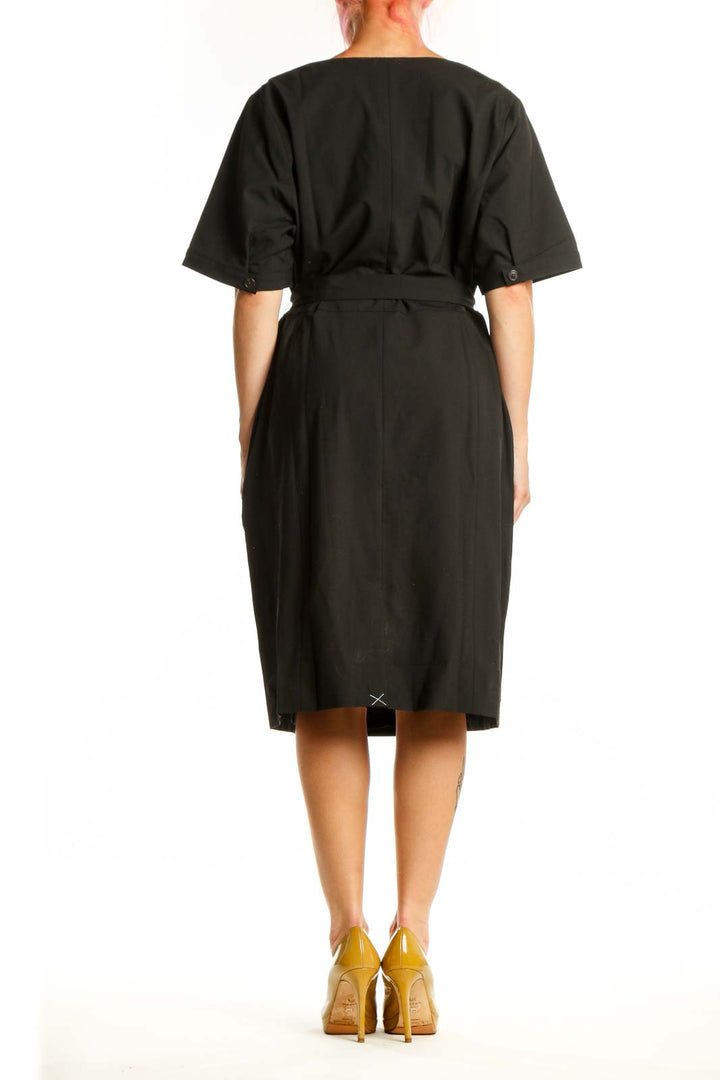 Black wrap midi dress with tie waist and side pockets, back view on model