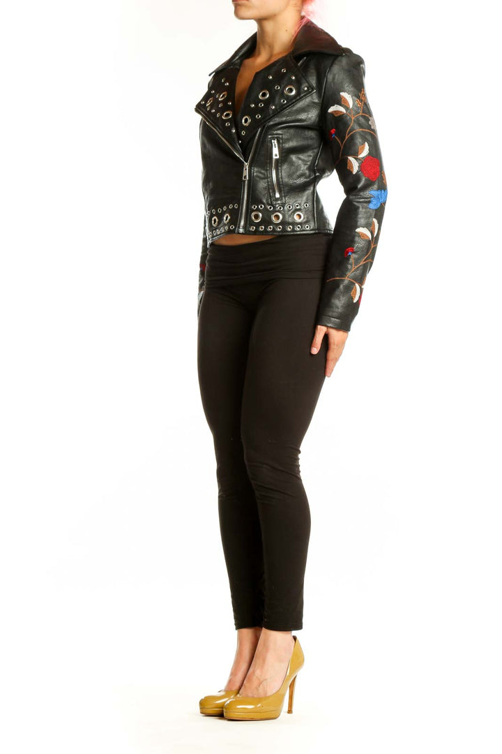 Black studded biker jacket with floral embroidery on sleeves, front view
