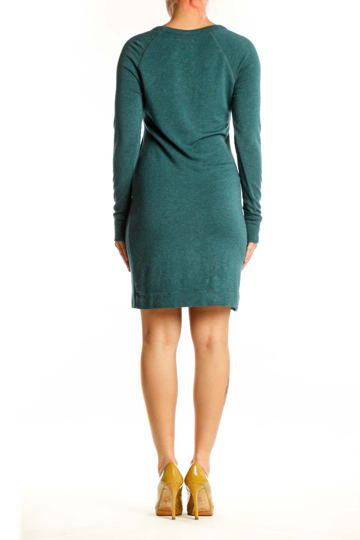 Back view of teal rayon spandex knit dress showing relaxed silhouette and knee length hem