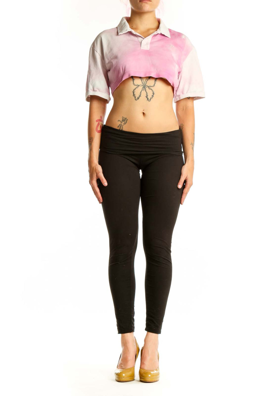 Pink and white cropped polo shirt with color-block design, short sleeves, and polo collar on model