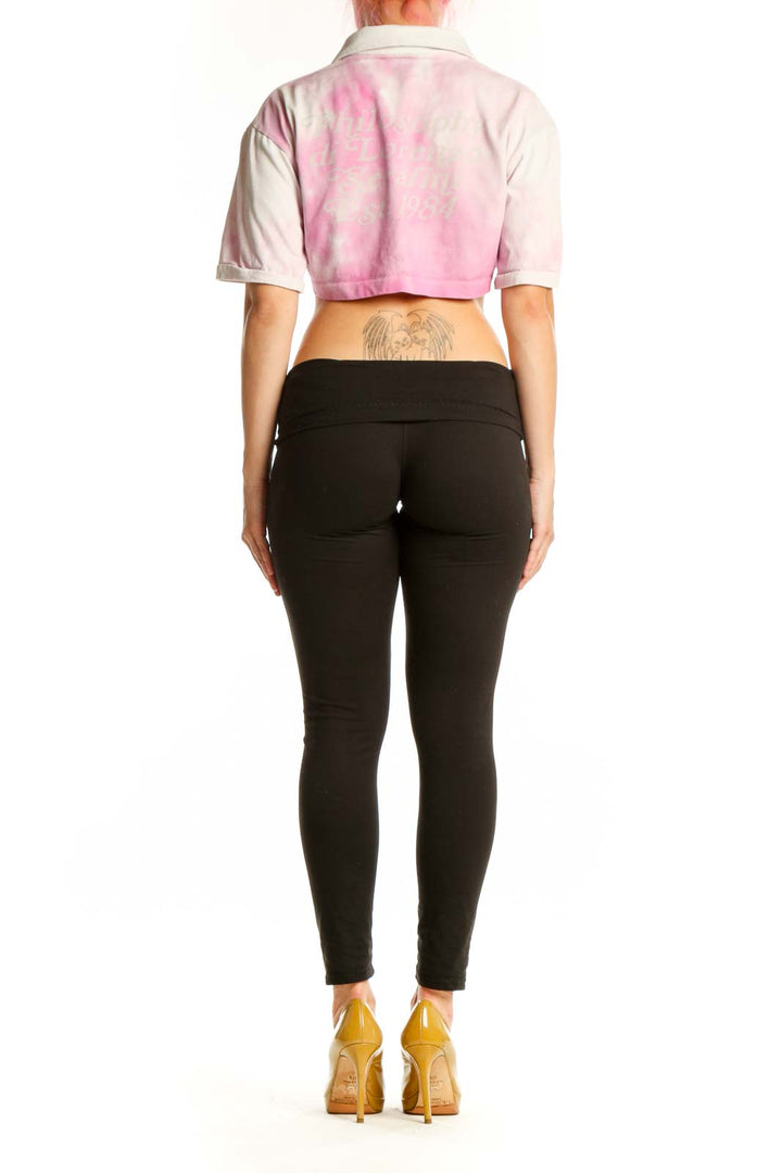 Back view of pink and white cropped polo shirt showing relaxed fit and cropped length