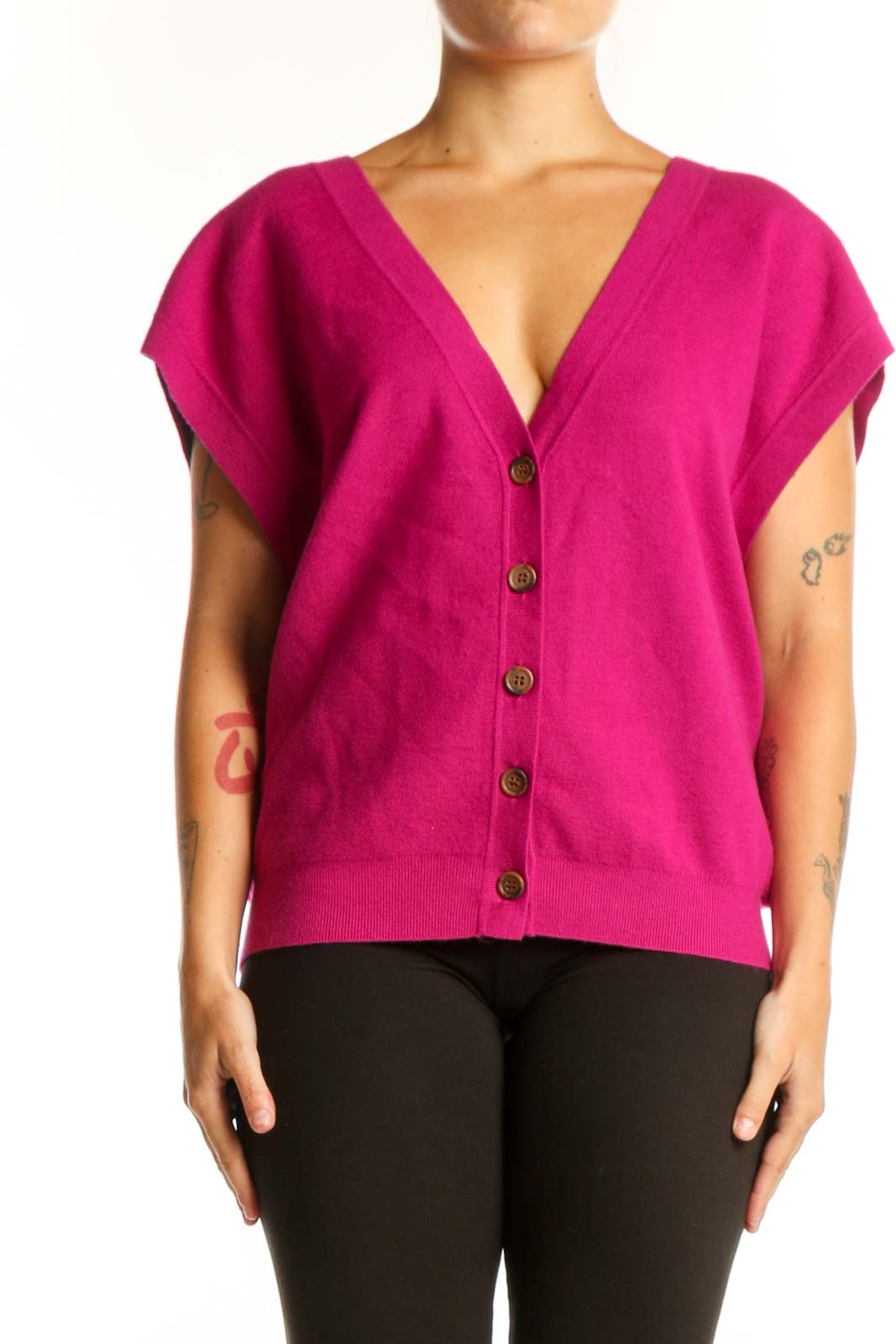 Pink button-front knit vest with V-neckline and cap sleeves, worn with black pants