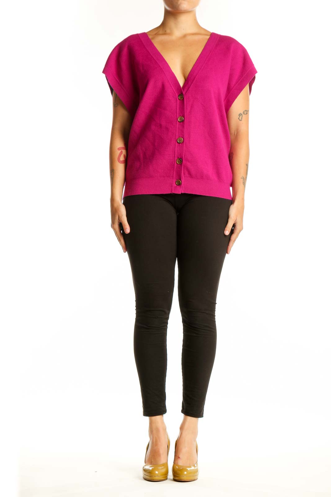 Pink button-front knit vest with V-neckline and cap sleeves, worn with black pants