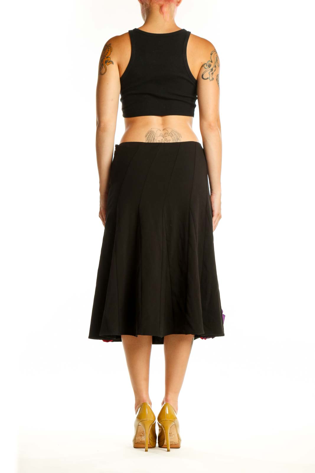 Black flare skirt with colorful floral embellishments, back view showing pleated waist and A-line silhouette