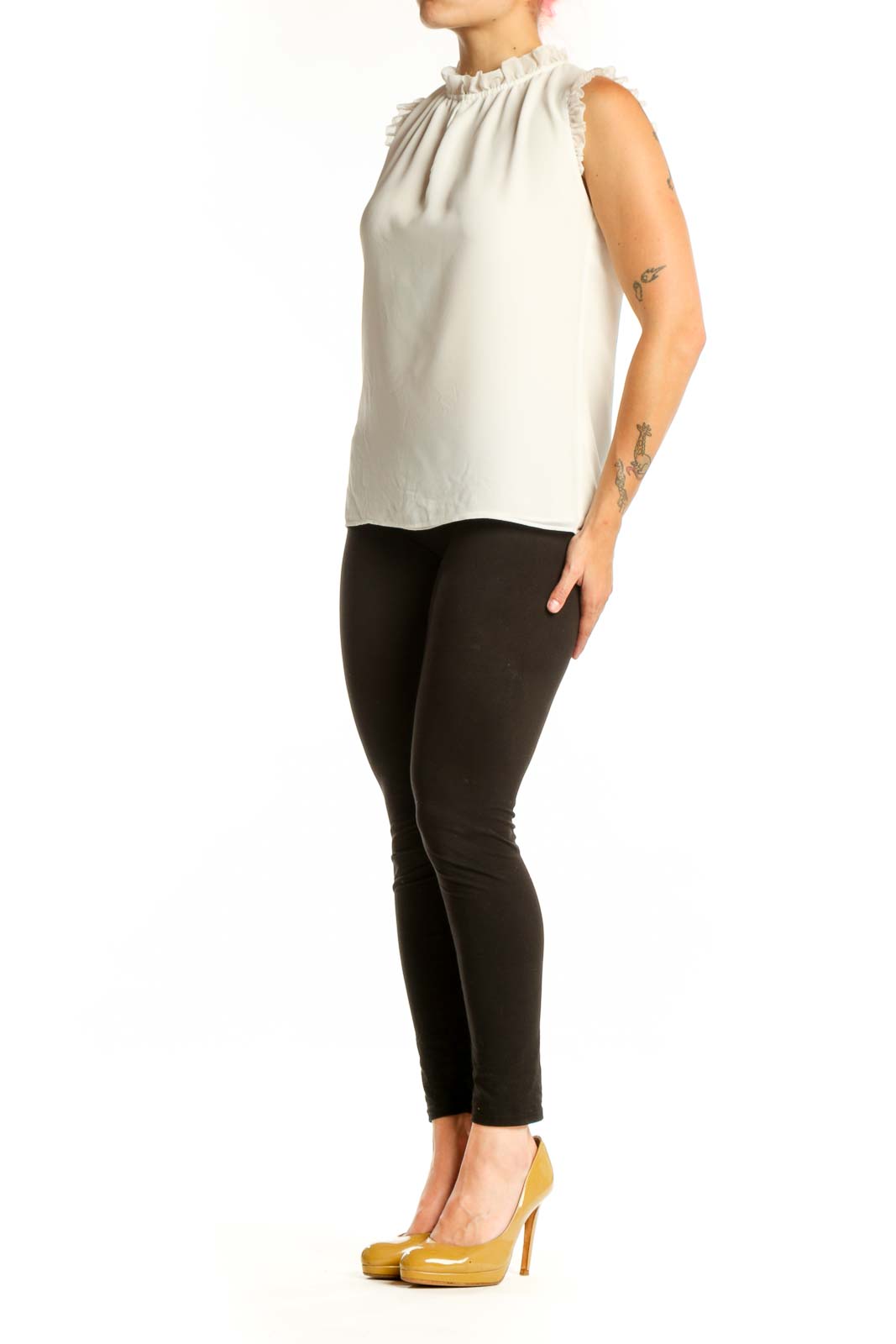Cream sleeveless top with ruffle shoulder details and crew neckline, front view
