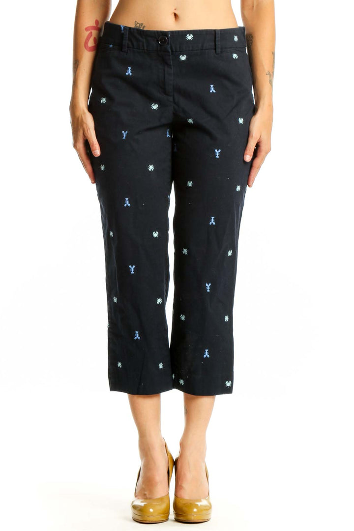 Navy embroidered capri pants with blue and white playful print, front view on model
