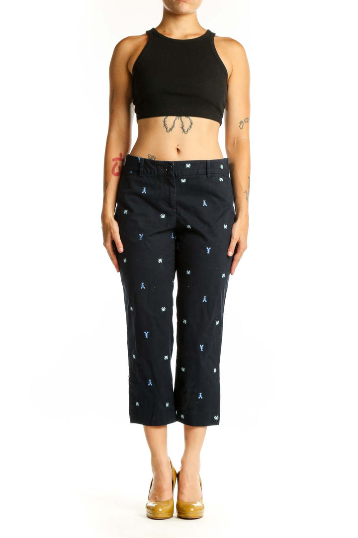 Navy embroidered capri pants with blue and white playful print, front view on model