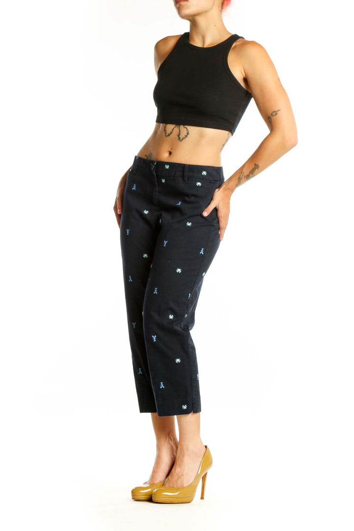 Navy embroidered capri pants with blue and white playful print, front view on model