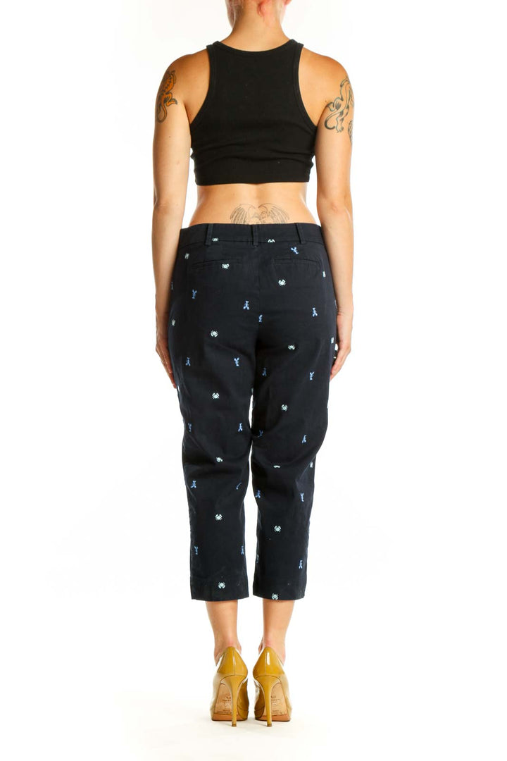 Navy embroidered capri pants with cropped silhouette, back view on model wearing black top