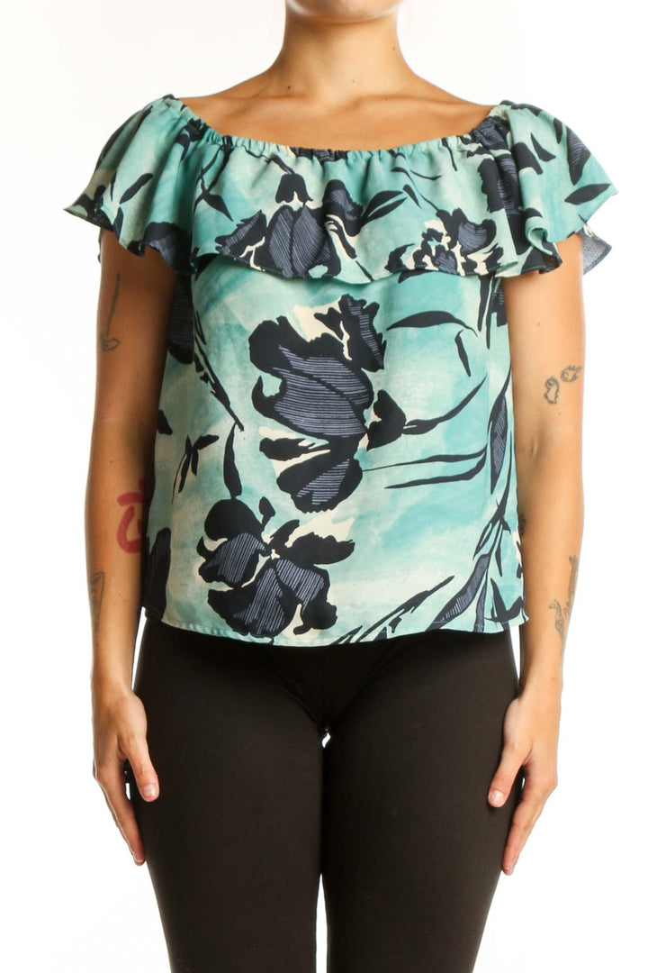 Mint green off-shoulder Maeve top with black floral botanical print and ruffled neckline, front view