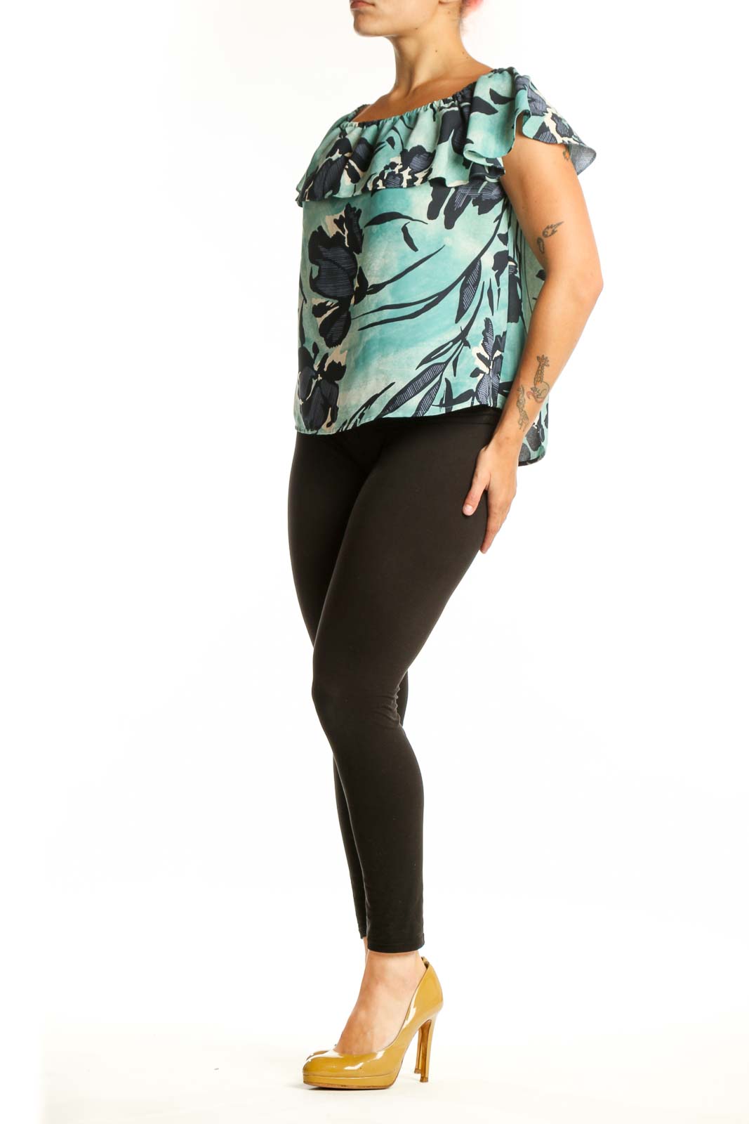 Mint green off-shoulder Maeve top with black floral botanical print and ruffled neckline, front view