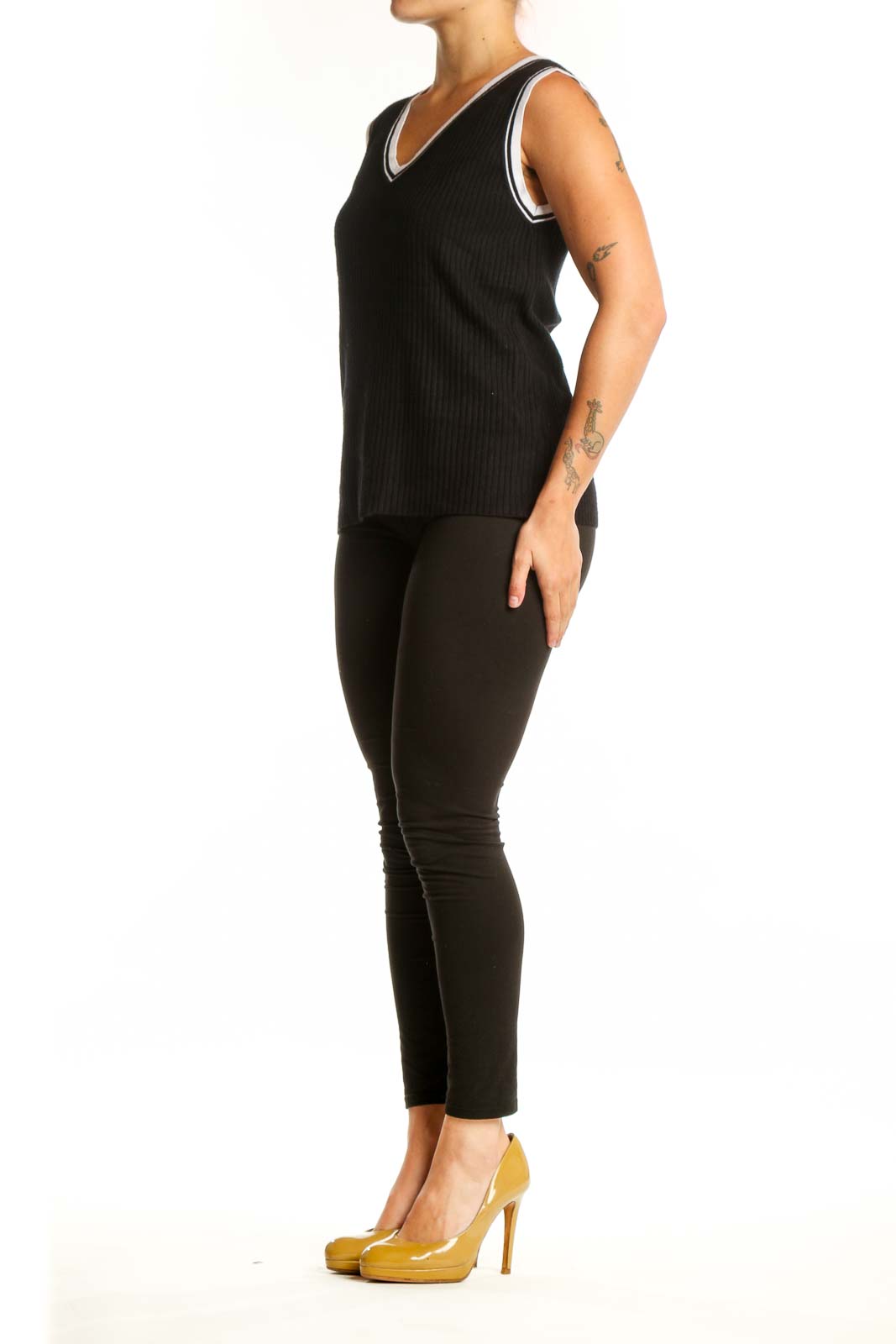 Black ribbed V-neck knit tank with white contrast trim, front view on model